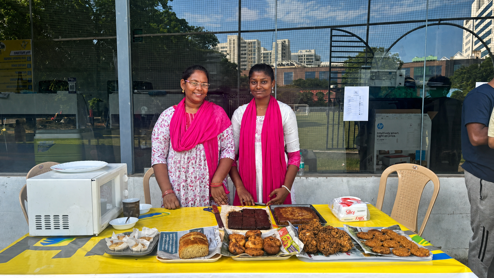 Women presenting baked goods developed through practical skills training
