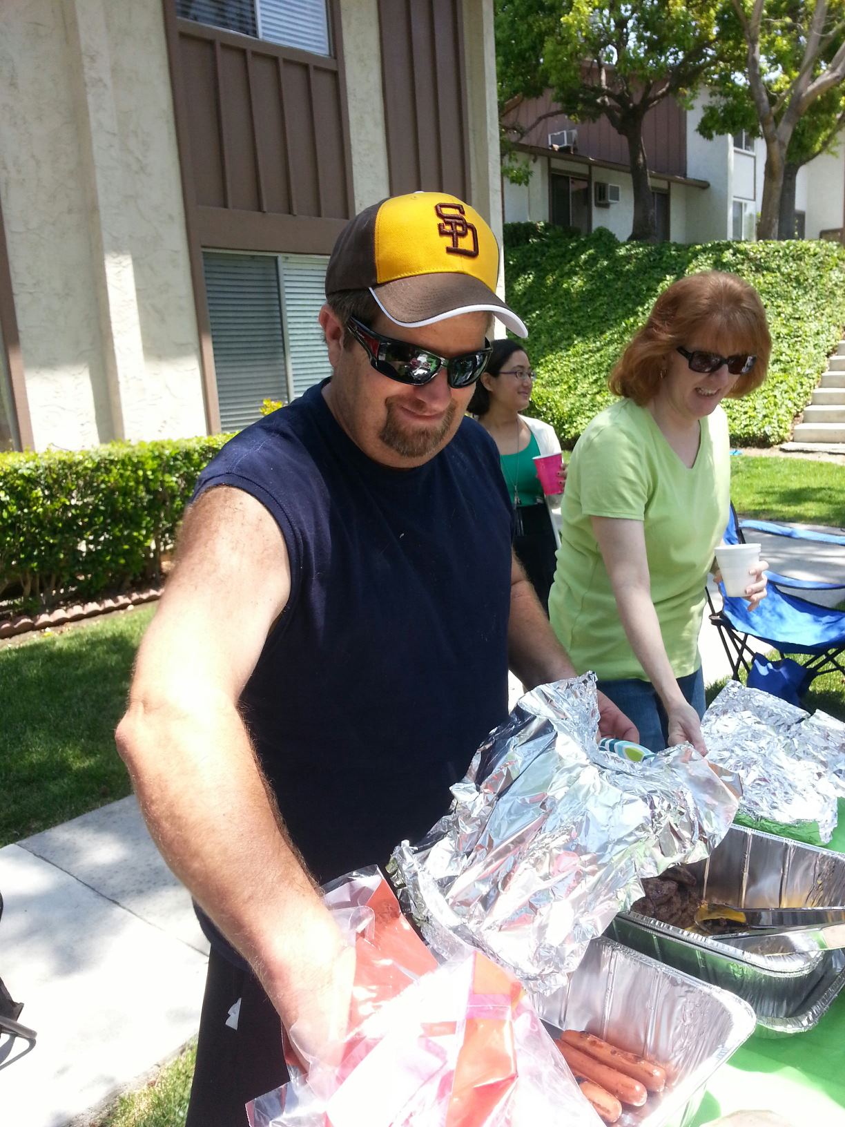 Neighbors serving food together at a community gathering