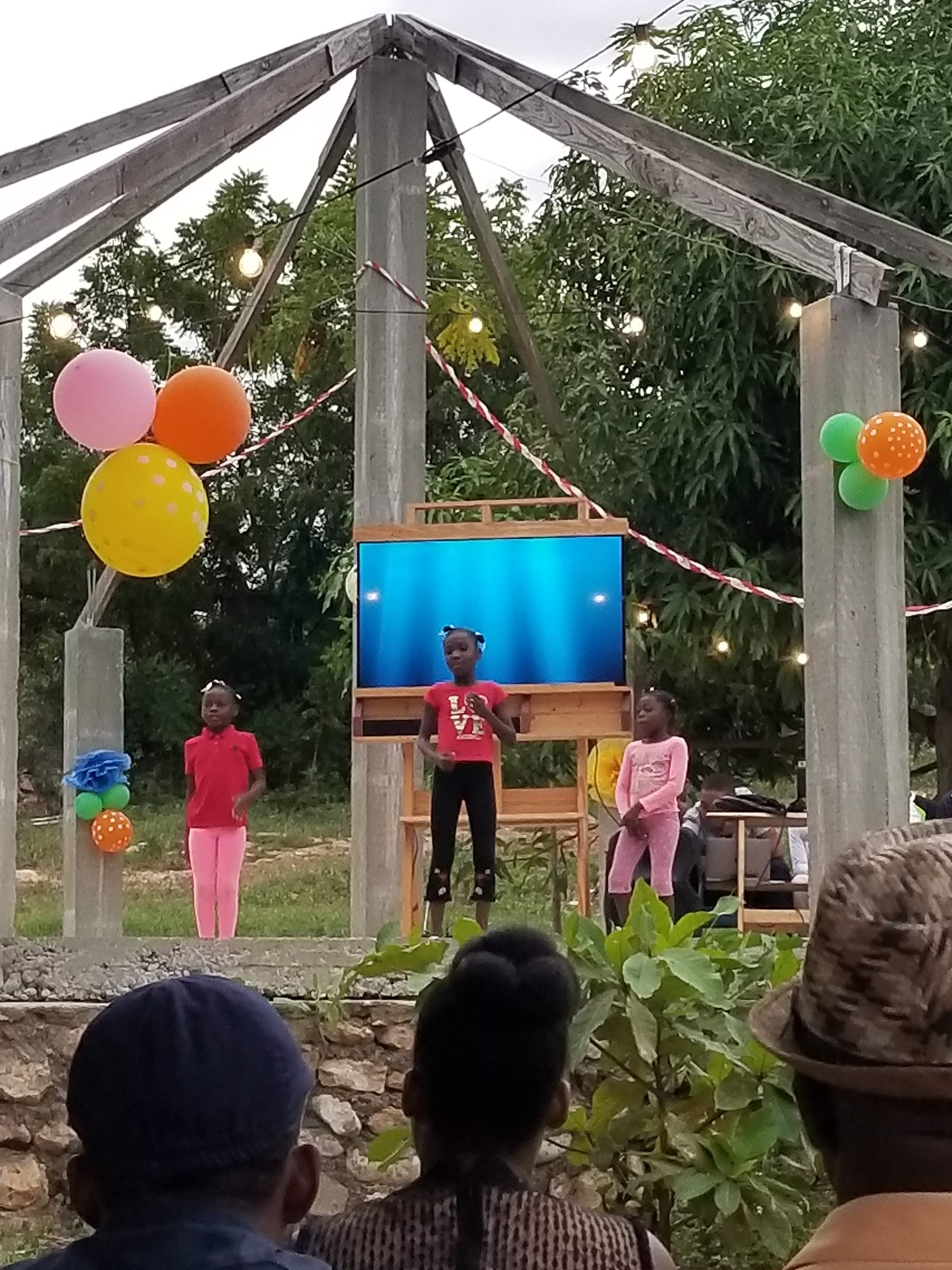 Young people sharing a presentation at a community event